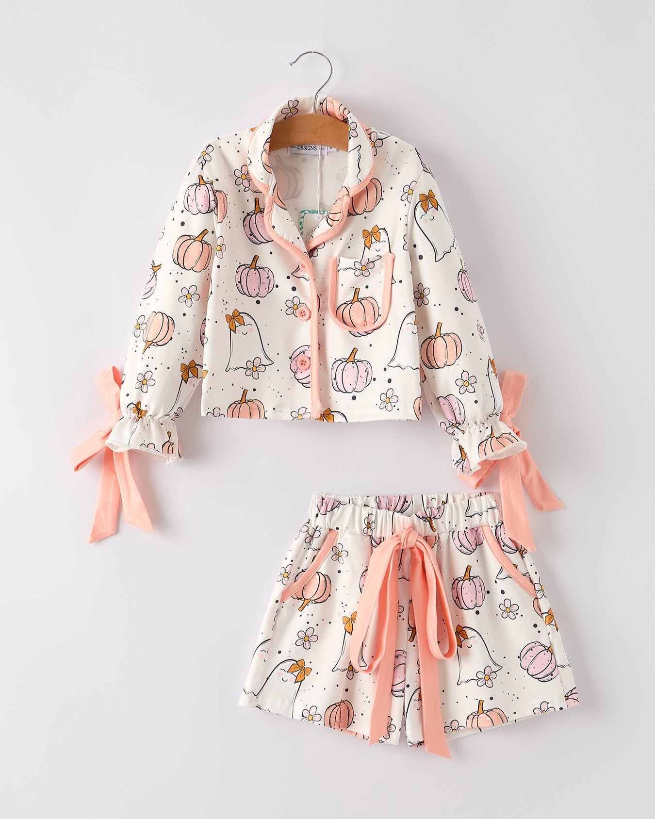 Children's pajama set with pumpkin pattern on a white background