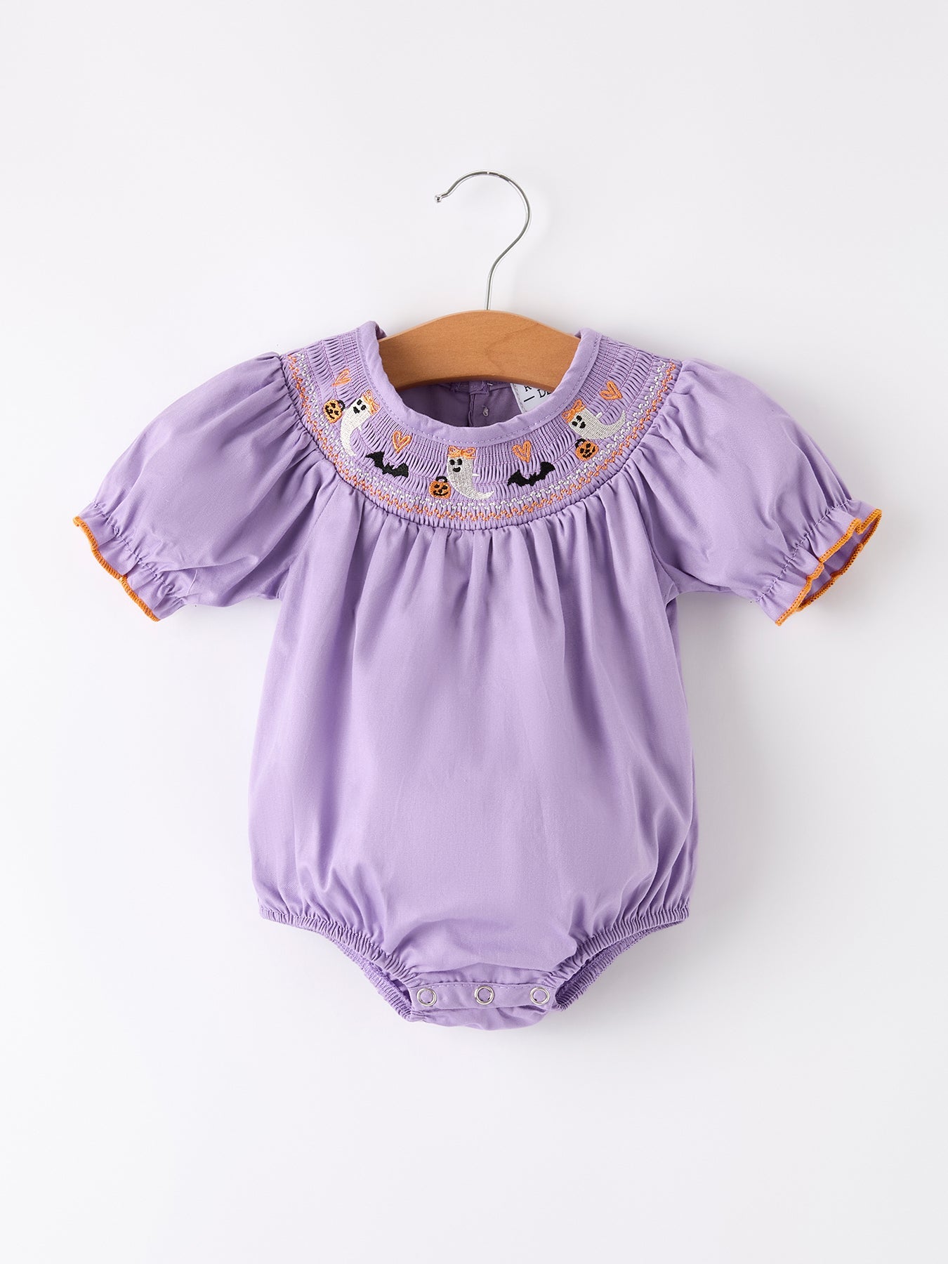 Purple baby romper with embroidered details on a white background