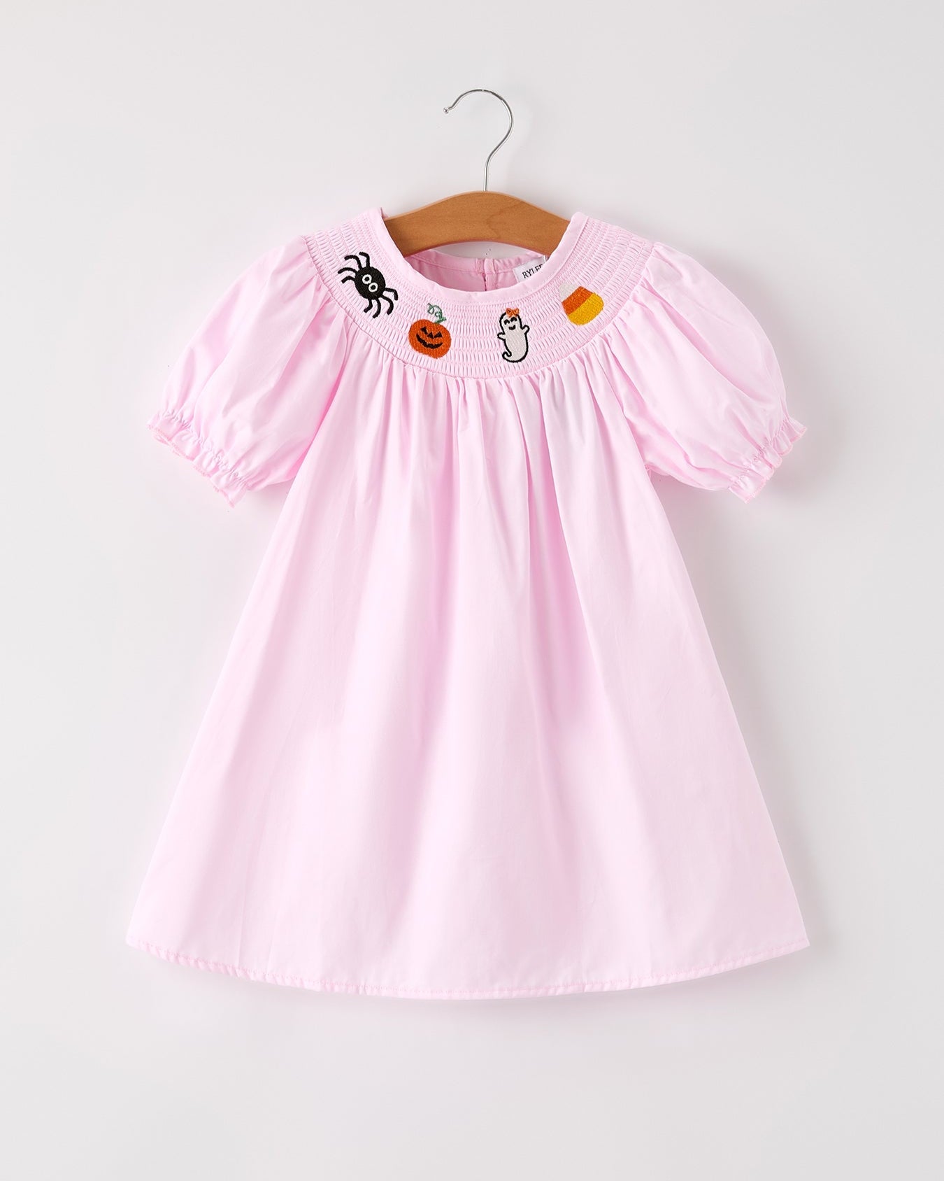 Pink dress with Halloween-themed embroidery on a white background