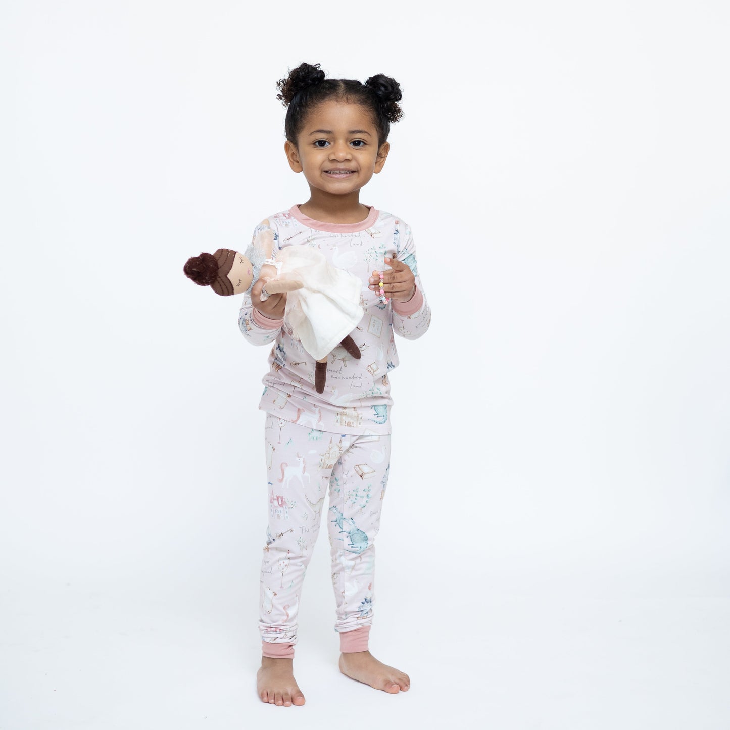 Child wearing pajamas with a white background