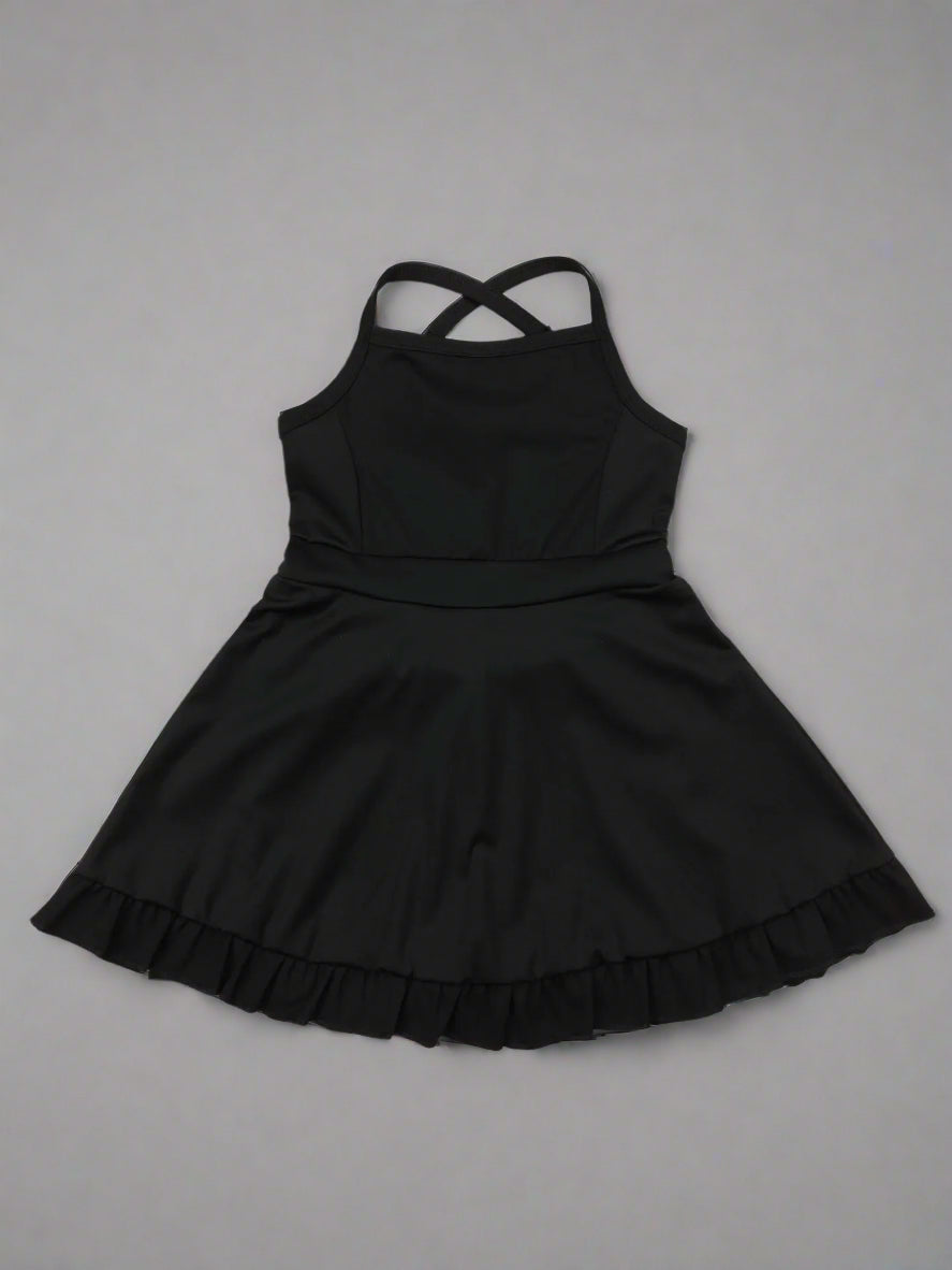 Black dress with ruffled hem on a wooden surface