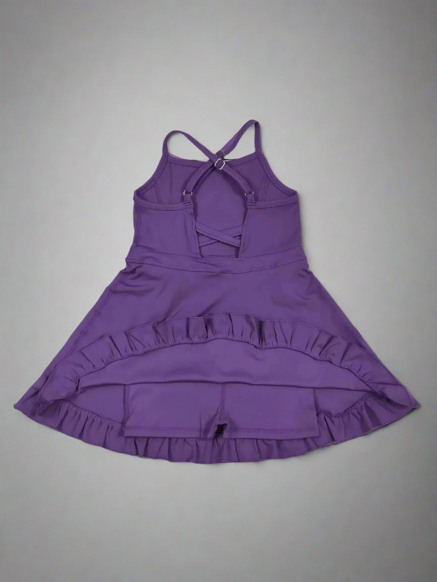 Purple dress with ruffled skirt on a wooden surface