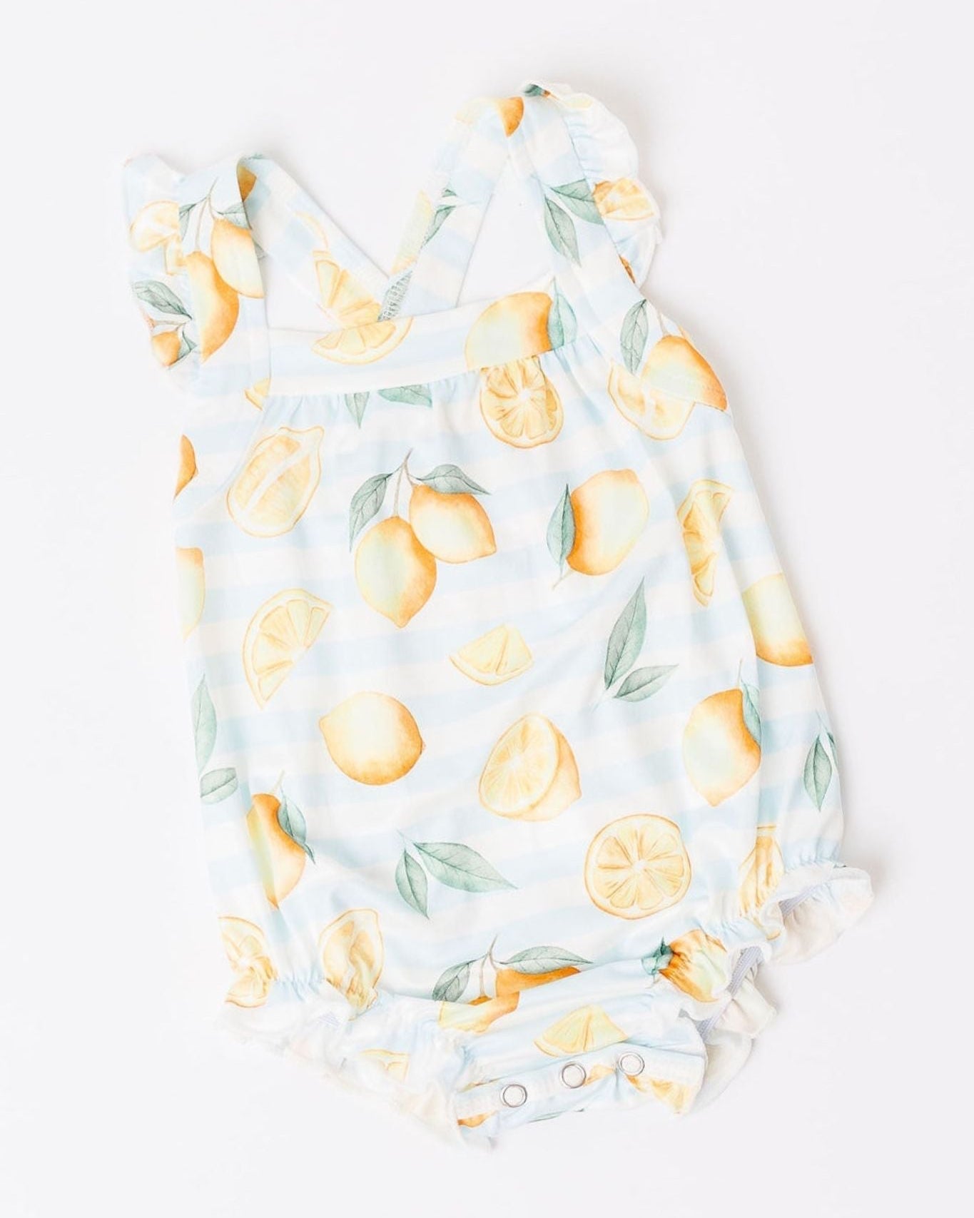 Baby onesie with lemon print on a white background