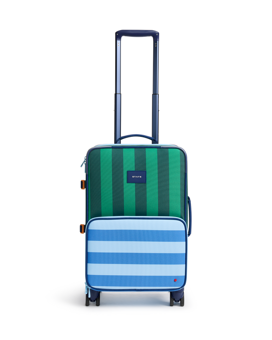 Green and blue striped suitcase on a white background