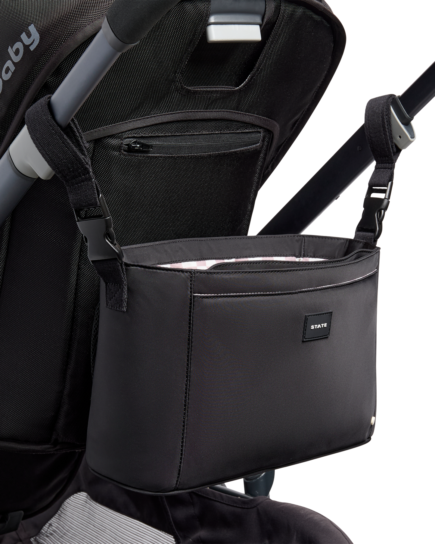 Black stroller organizer attached to a stroller on a white background