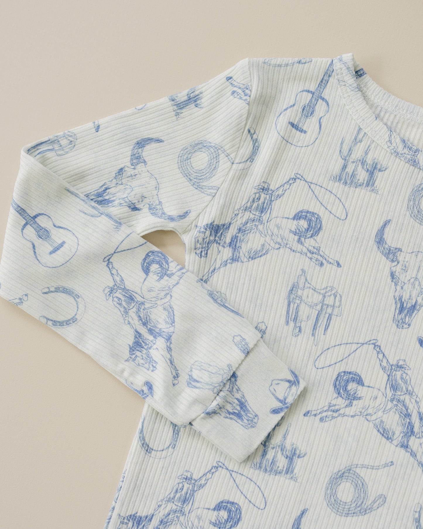 Light blue fabric with blue animal print on a beige background