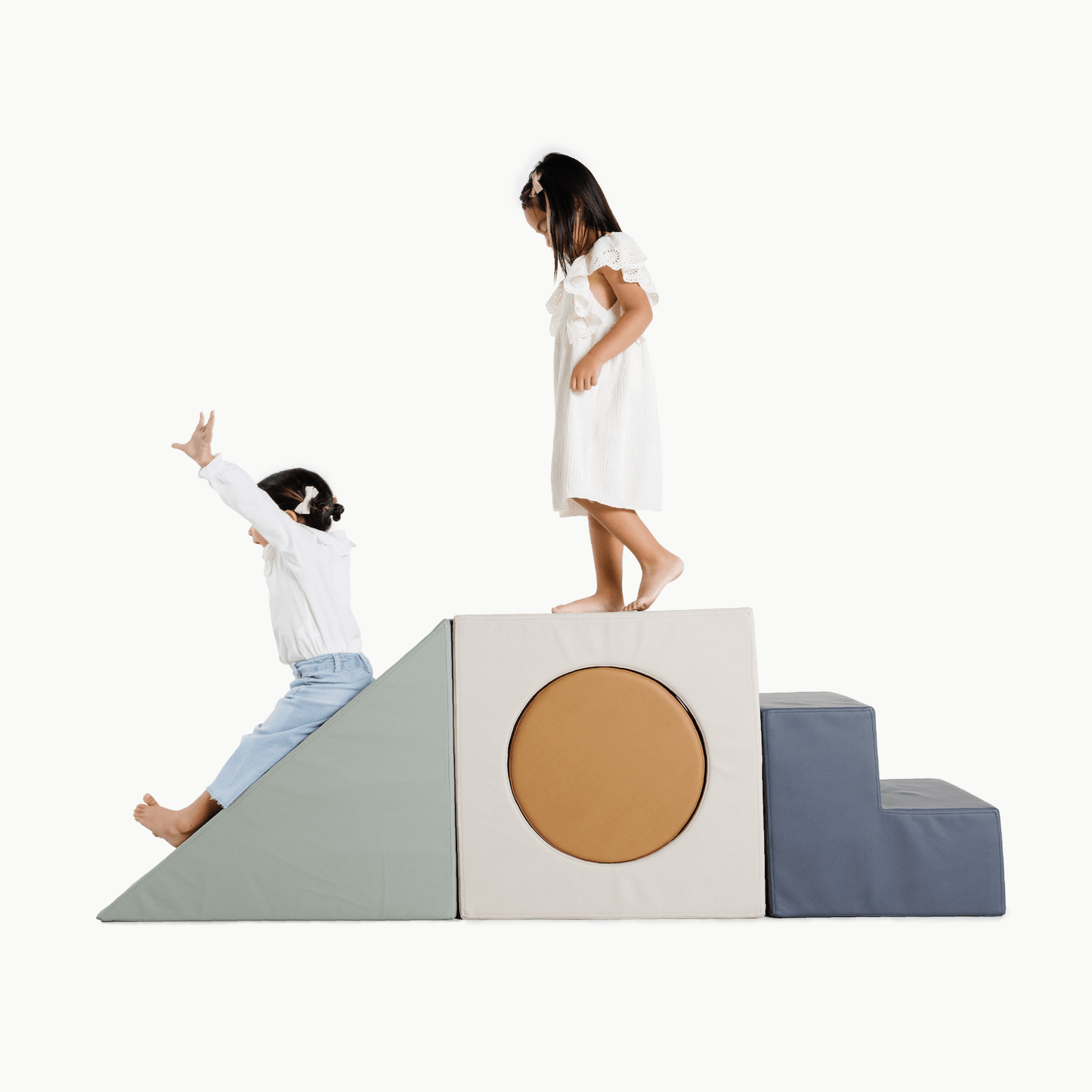Children playing on a soft play structure with a white background