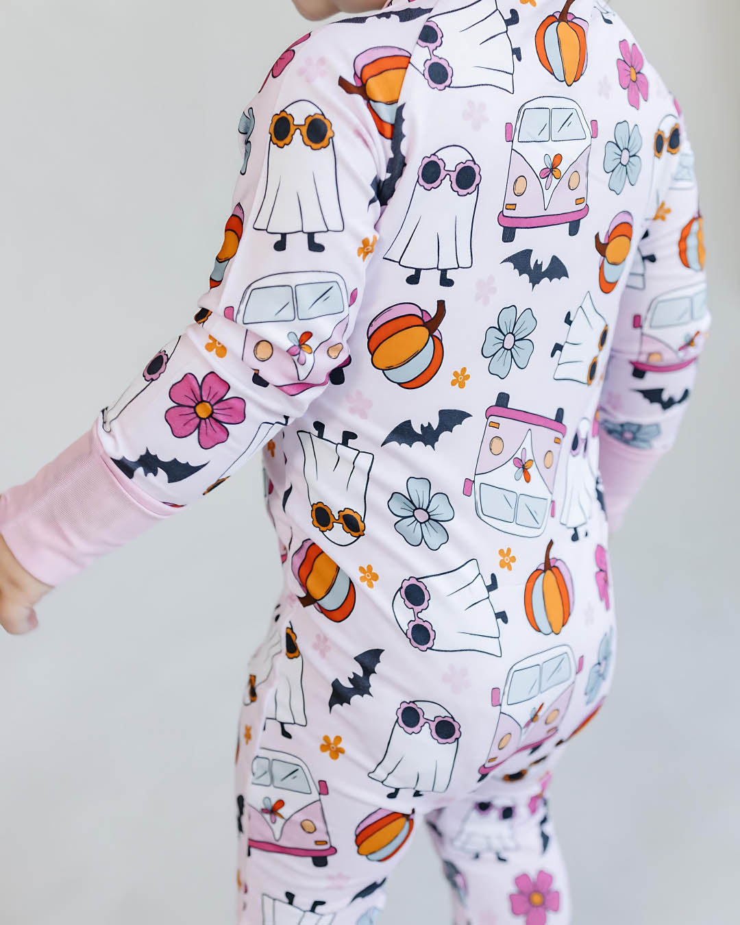 Children's onesie with Halloween-themed pattern on a plain background