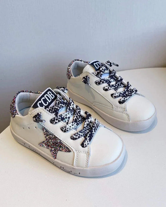 White sneakers with decorative laces on a white surface