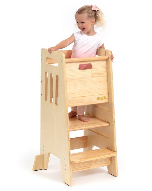 Child playing with a wooden playhouse on a white background
