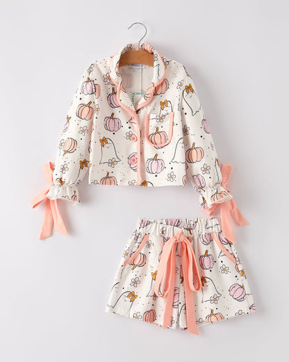 Children's pajama set with pumpkin pattern on a white background