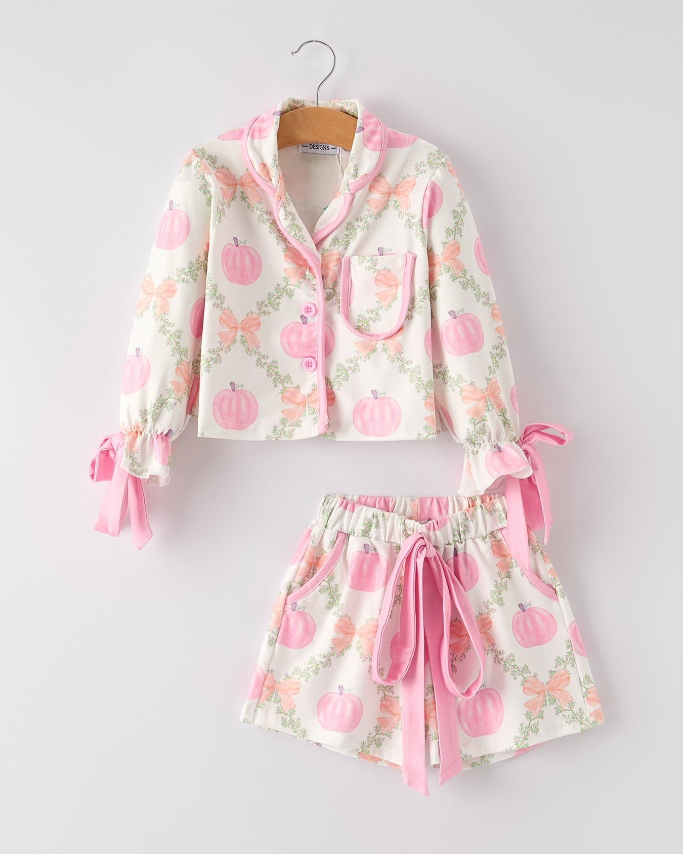 Floral pajama set with pink accents on a white background