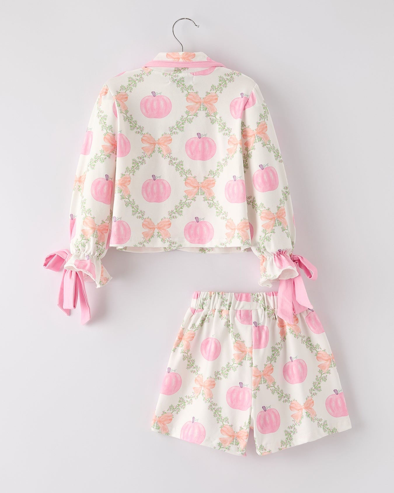 Children's pajama set with pink pumpkins on a white background