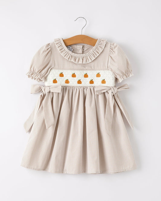 Beige dress with pumpkin pattern on a white background