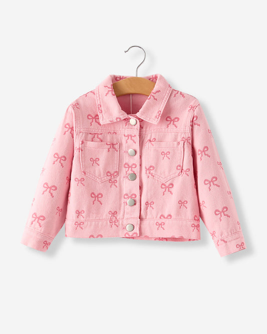 Pink denim jacket with bow pattern on a hanger against a white background