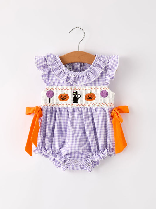Baby romper with Halloween design on a hanger against a white background