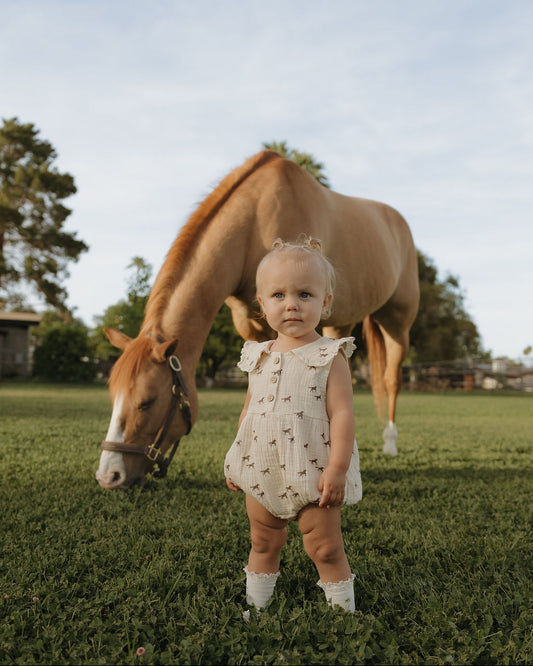 Child in a field with a horse
