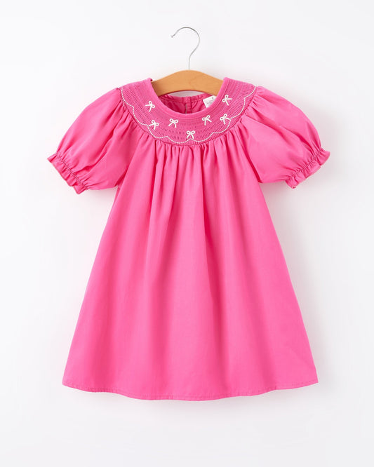 Pink dress with embroidered collar on a white background