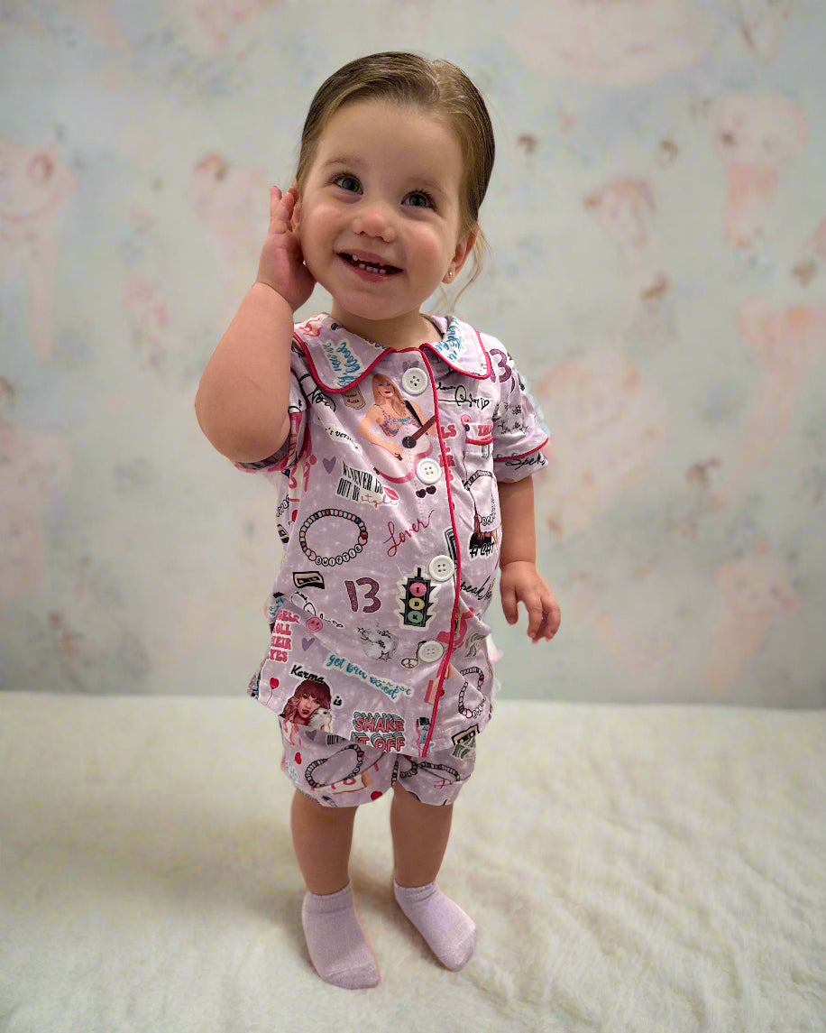 Child in a swiftie inspired Pajamas standing on a tiled floor