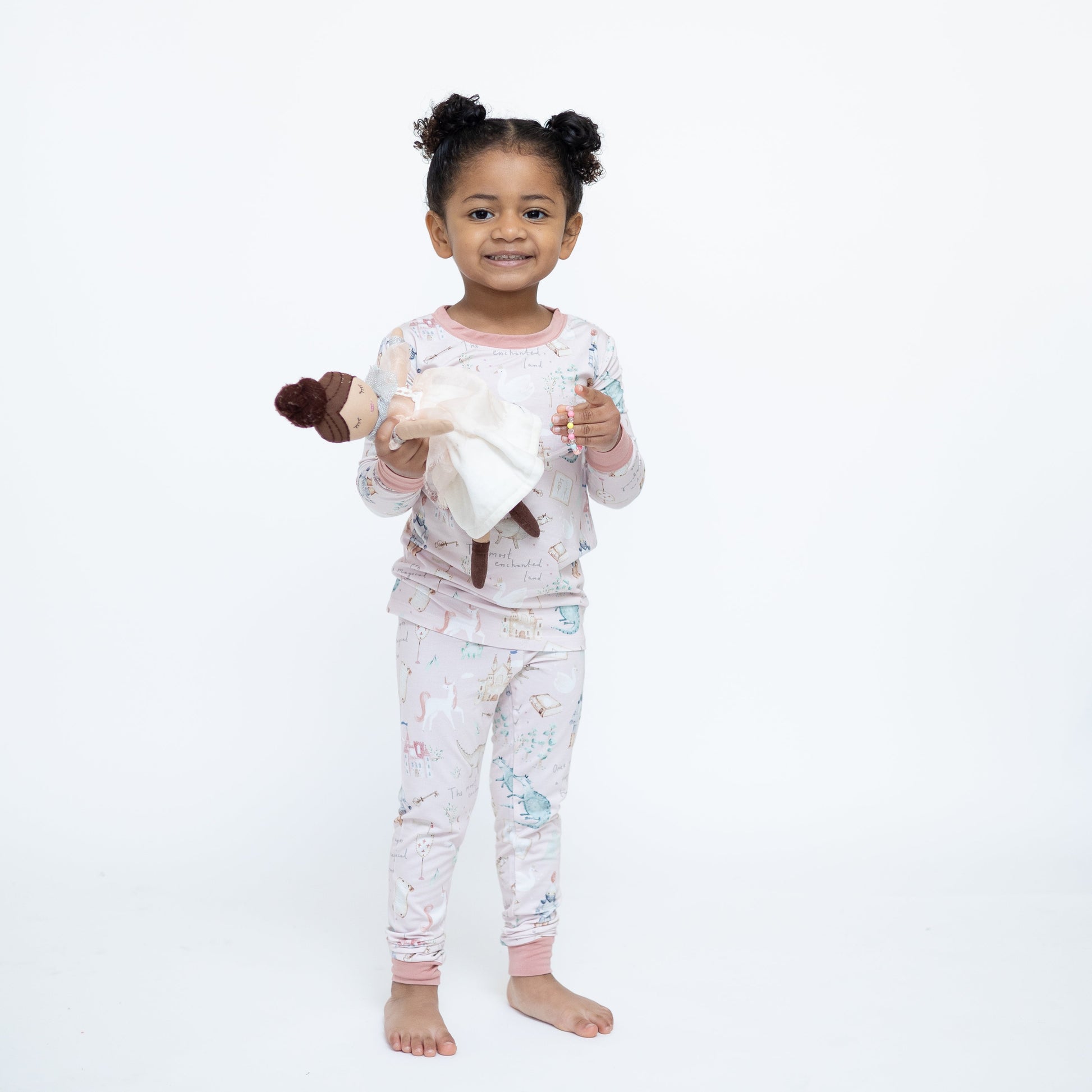 Child wearing pajamas with a white background