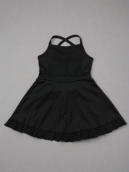 Black dress with ruffled hem on a wooden surface
