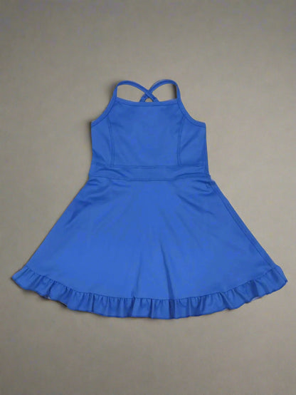 Blue dress with ruffled hem on a wooden surface