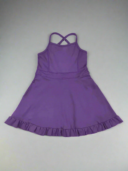 Purple dress with ruffled hem on a wooden surface