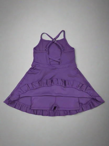 Purple dress with ruffled skirt on a wooden surface