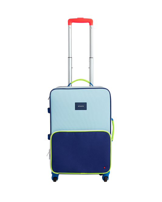 Two-tone blue and navy suitcase with a red handle on a white background