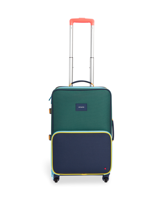 Green and navy State Bag suitcase with a visible brand logo on a white background