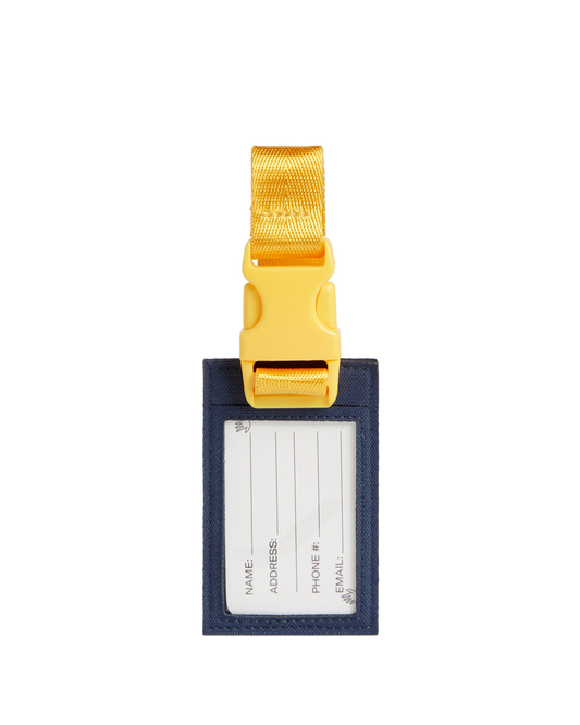Luggage tag with gold buckle on a white background