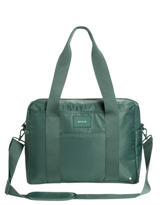 Green diaper bag with a visible brand label on a white background