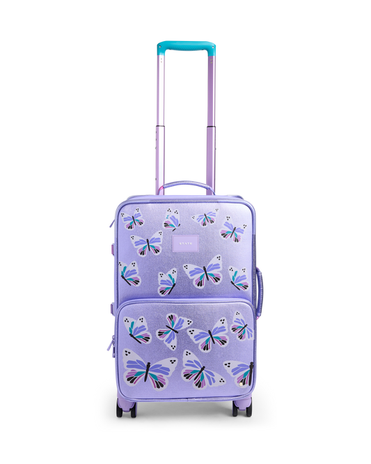 Purple suitcase with butterfly design on a white background
