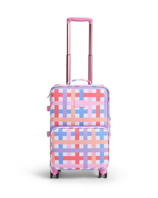 Checkered patterned suitcase with pink handle on a white background