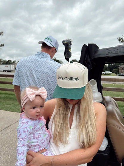 He's Golfing - Green Vintage Trucker Hat