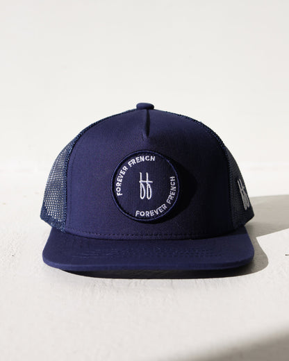 Navy blue cap with a brand logo on a light background