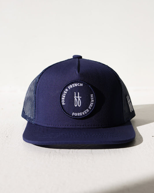 Navy blue cap with a brand logo on a light background